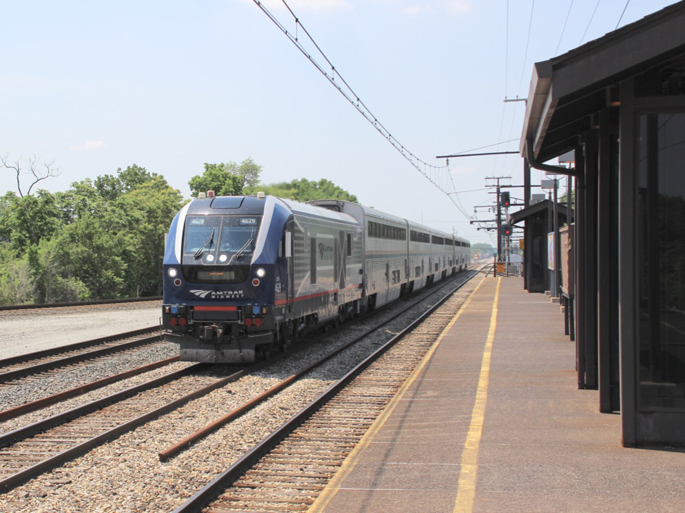 Passenger train passes station