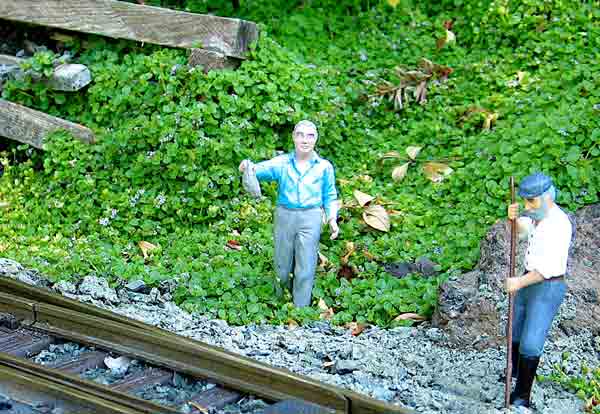 Coriscan mint in the background of two figurines next to track
