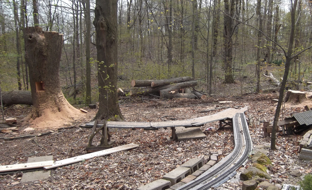 A garden railroad with cut trees