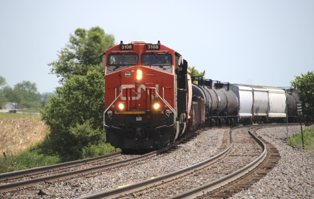 Train with red and black locomotives on curve