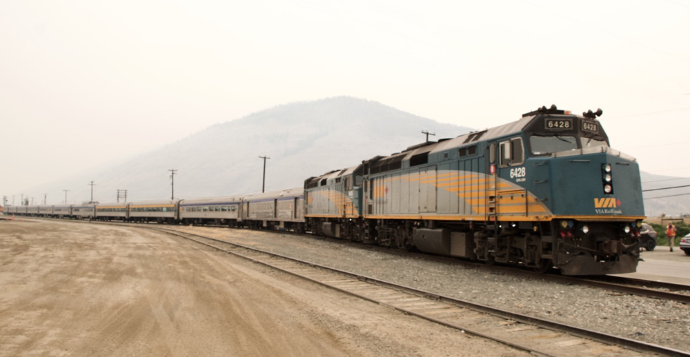 Parked passenger train under smoky skies