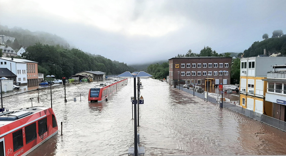 Two trains partially submerged in flood waters