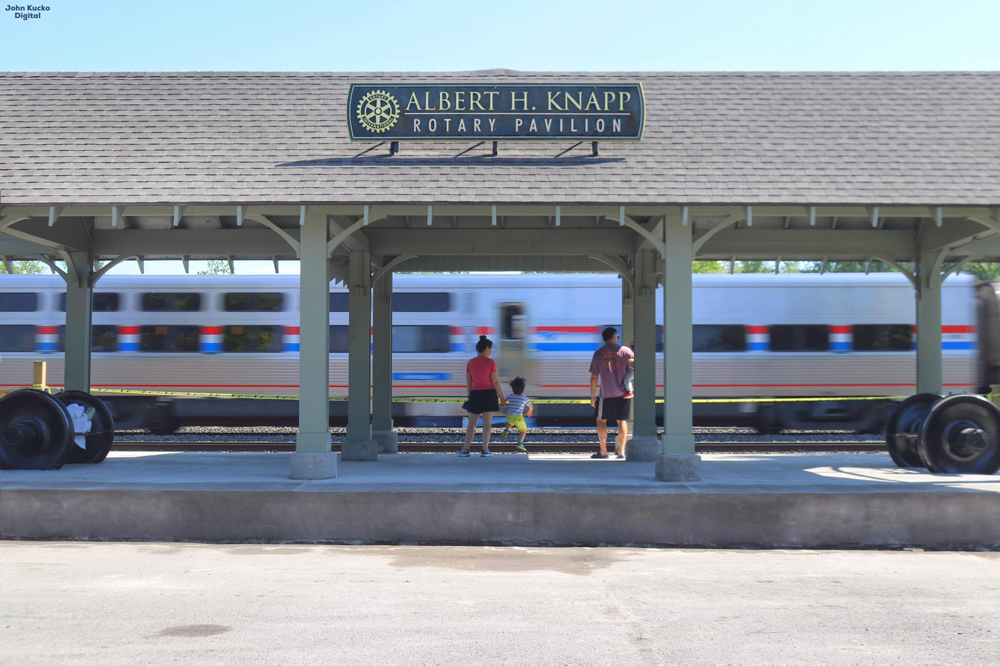 Railfan viewing platform with Amtrak train passing in background