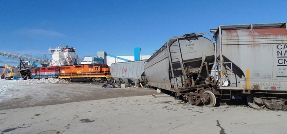 Two derailed locomotives and derailed hopper cars