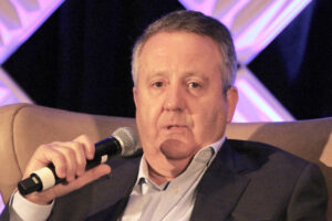 seated man in suit with microphone