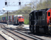 Electrified commuter train meets two freight trains