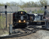 Black locomotive leads train through sharp curve