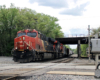 Train with two engines passes under bridge