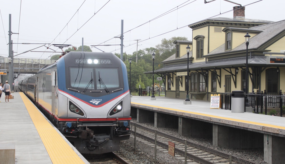 Train with electric locomotive passing station