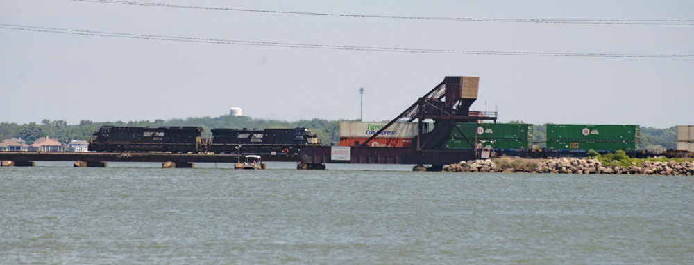 Train with black locomotives on bridge