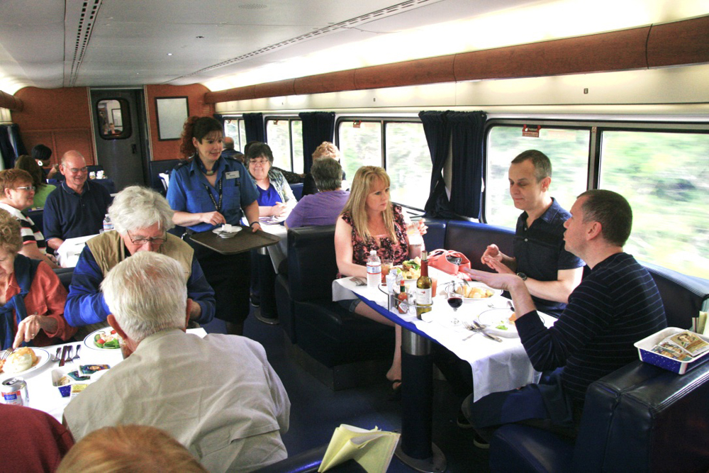 Dining tables of passenger car filled with passengers