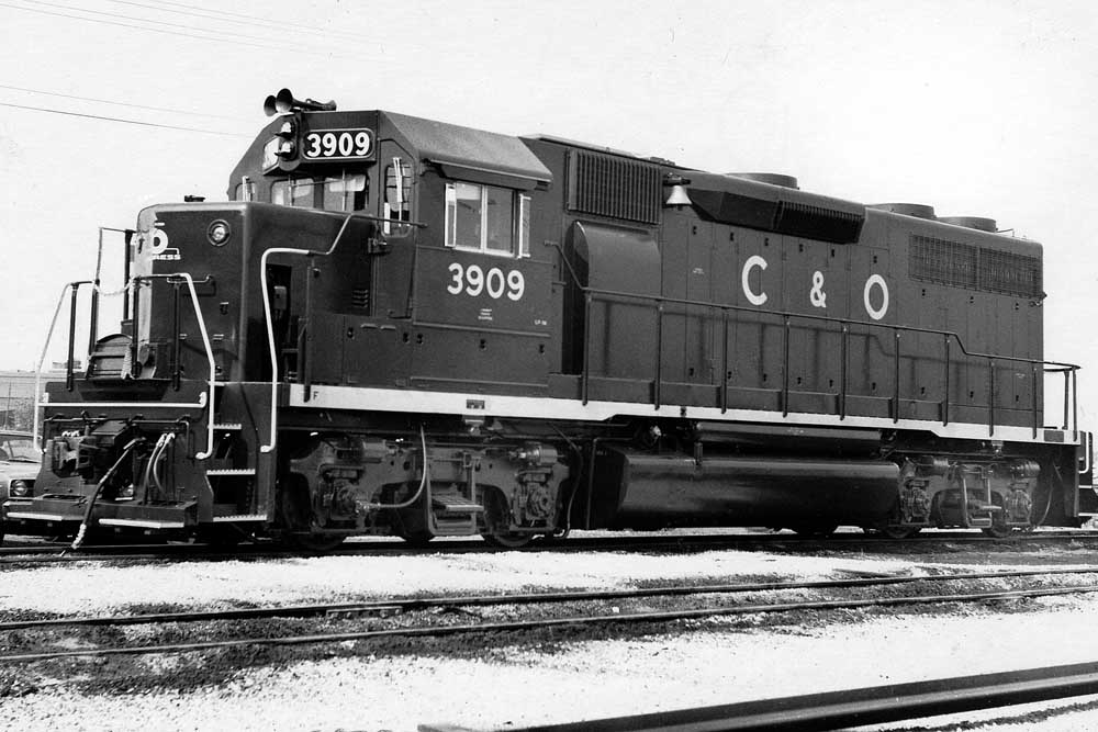 Three quarter view of dark blue diesel locomotive with light yellow lettering