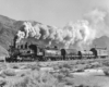 Black-and-white view of 4-6-0 steam locomotive with 3-car train
