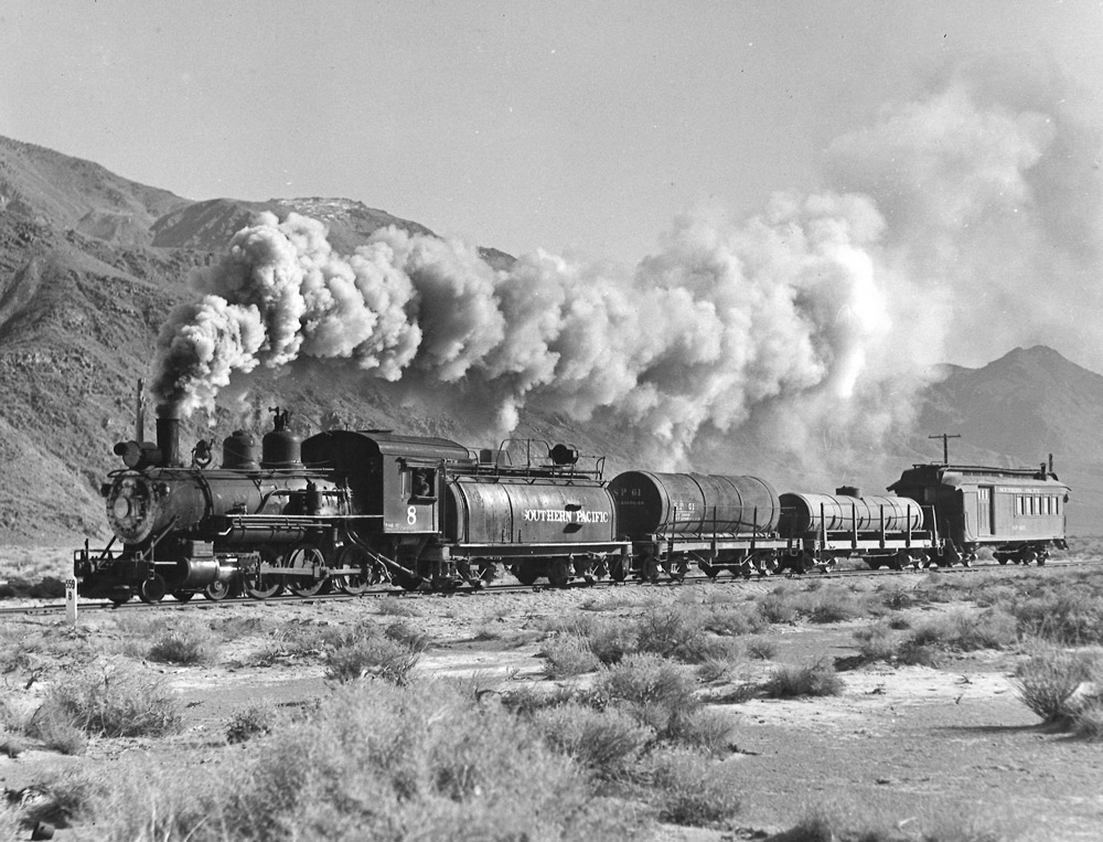 Black-and-white view of 4-6-0 steam locomotive with 3-car train