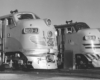 Black-and-white view of the noses of two streamlined diesel locomotives