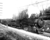 Three steam locomotives led by an 0-8-0 switcher on an incline in a black-and-white image.