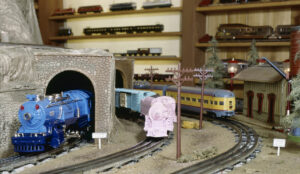 Three toy train engines on a layout