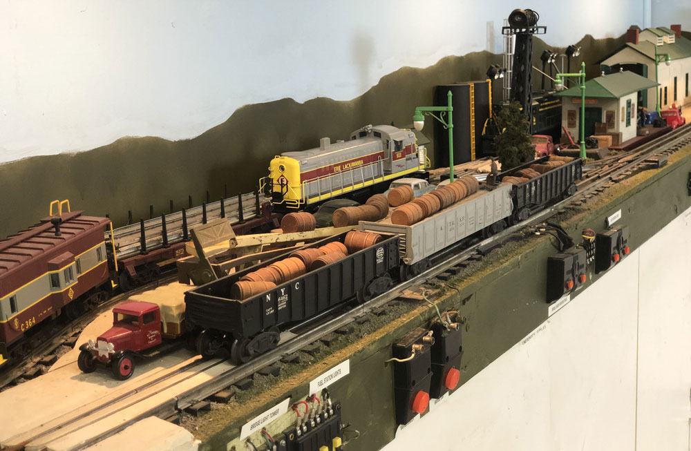 Part of John Hudak’s O gauge layout showing Lionel barrel cars and an engine service area