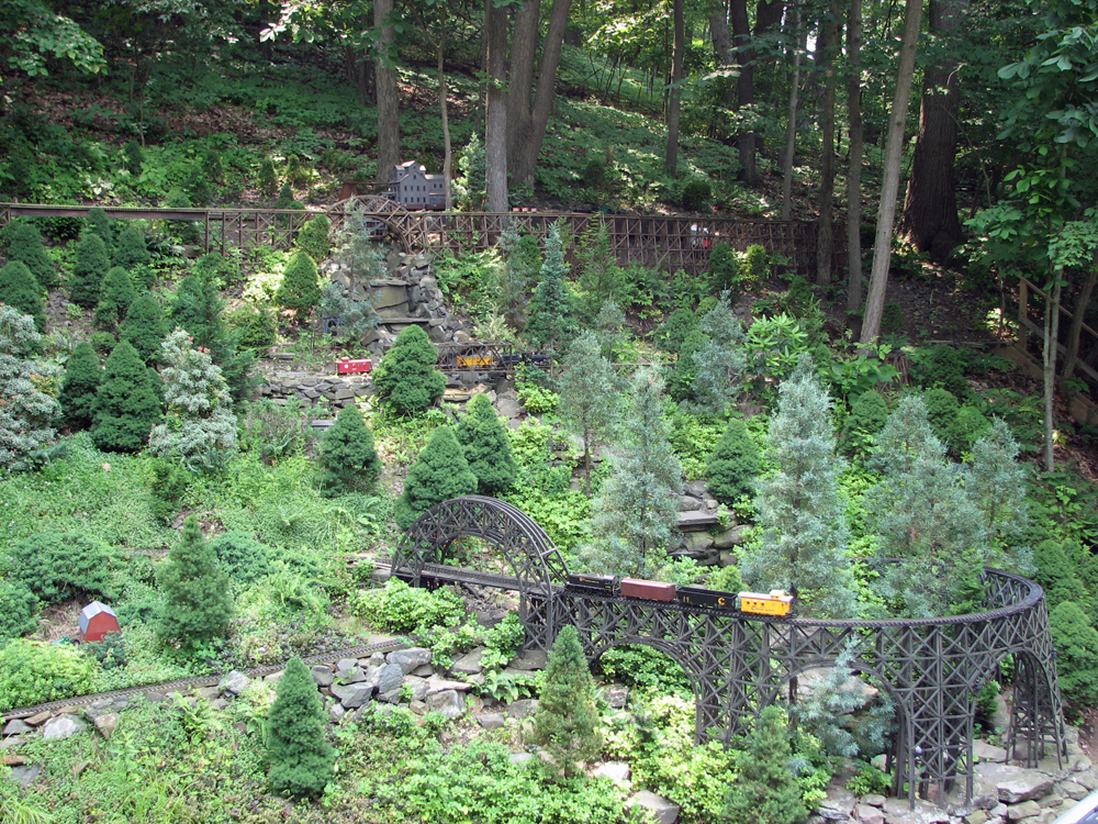 A garden railway built on a slope with trestles