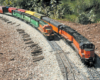 Two model freight trains on a curve