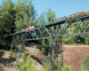 Two model diesels on a high trestle