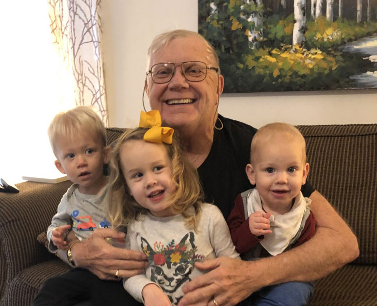 John Hudak poses with his three young grandchildren