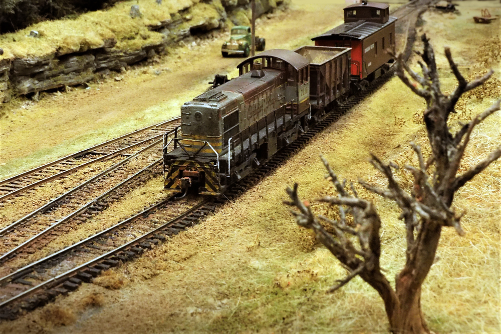 A Canadian Pacific Alco S-2 pulling a single ore car.