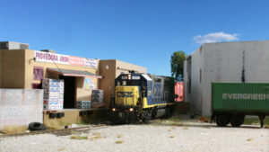 Locomotive next to two industries