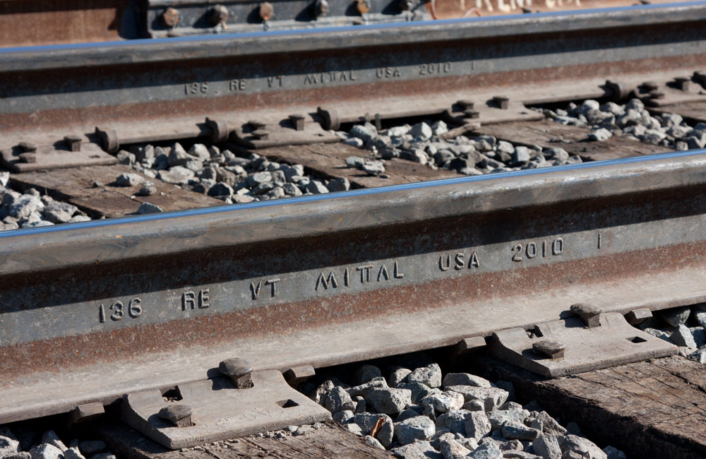 A close side view of newly installed rail on a CSX main line shows lettering in the web of the rail.