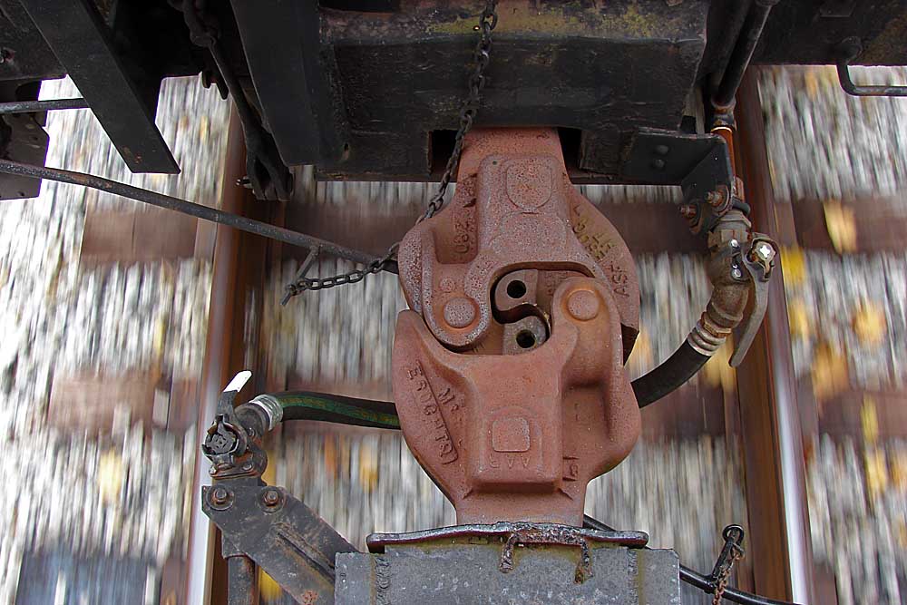 Looking down on a coupler connection between cars at speed
