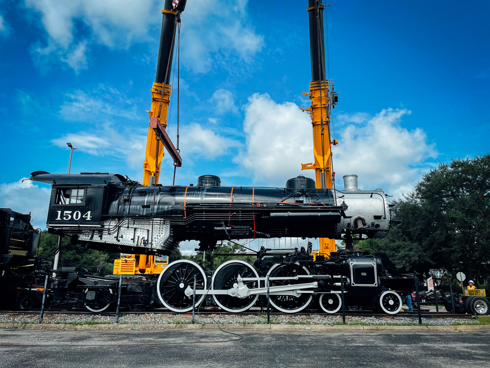 Lomotive being lifted by cranes