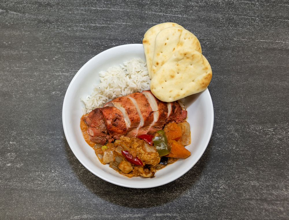 Chicken meal on white plate with bread