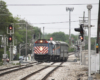 Commuter train crosses from one track to another on double-track main line.