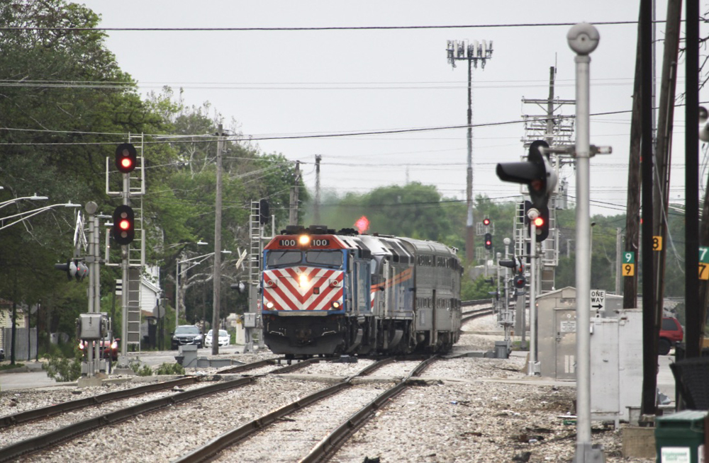 Commuter train crosses from one track to another on double-track main line.