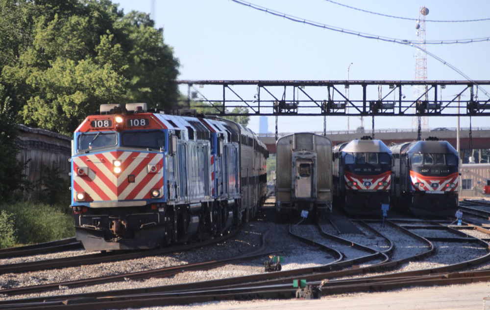Train on main line passes three parked trains.
