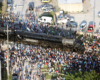 Paused Big Boy steam locomotive surrounded by large crowd of people.