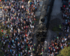 Close up overhead image of Big Boy surrounded by people at a stop.