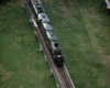 Big Boy steam locomotive in a low-light scene on an elevated viaduct.