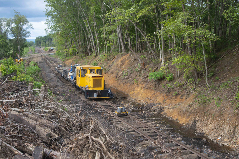 Small diesel and flatcar on track under repair