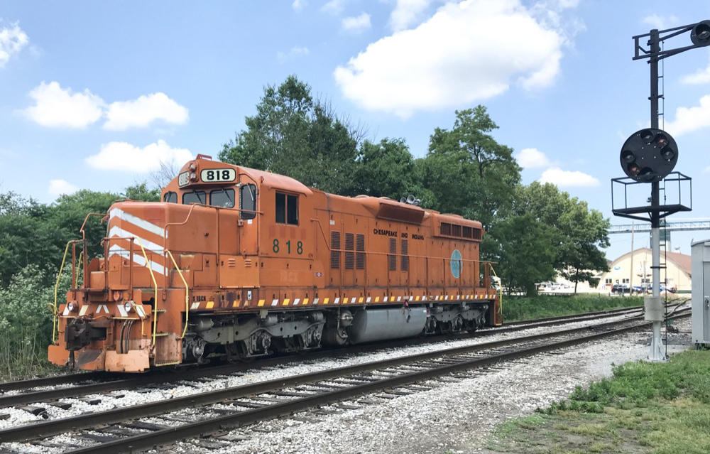 Orange locomotive next to color position signals