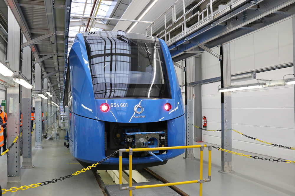 Blue passenger train in shop building