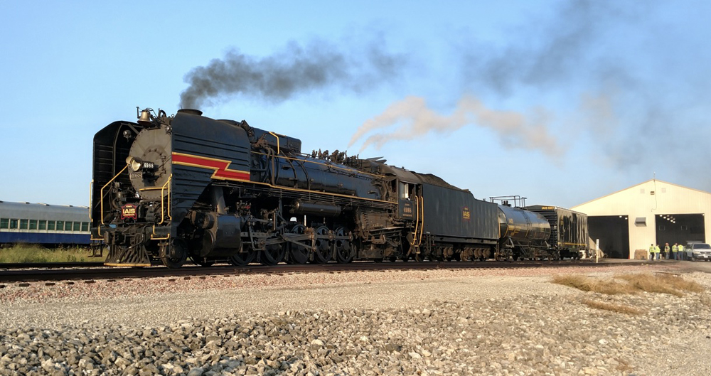 Steam locomotive leaves shop building