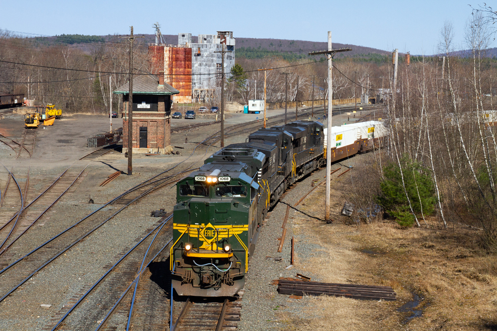 Train at rail yard with tower in background