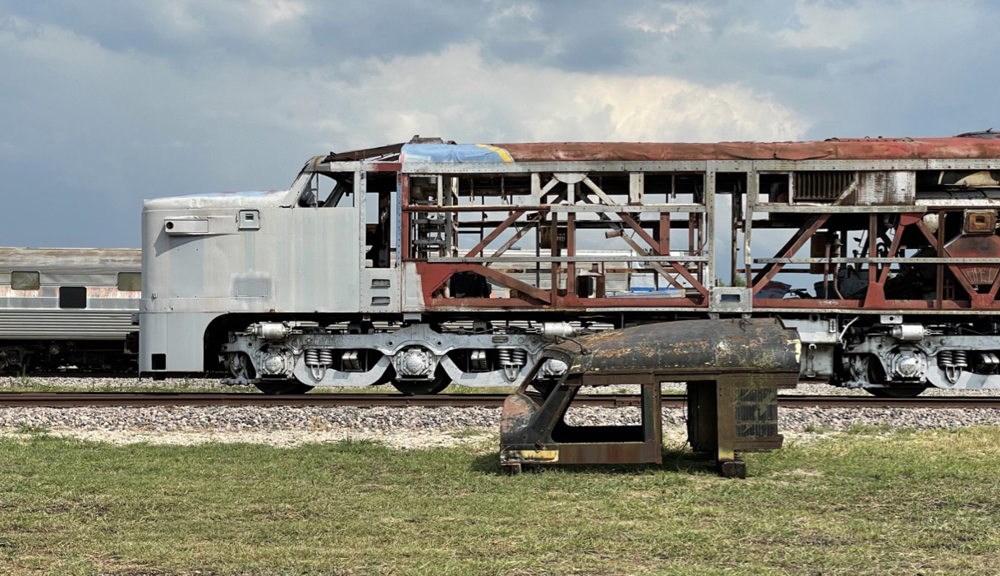 Nose and frame of locomotive with roof section in foreground