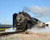 Close-up view of a steam locomotive in a yard.