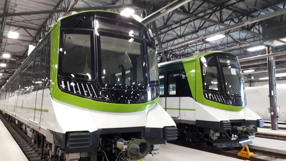 Green and white light rail trainsets