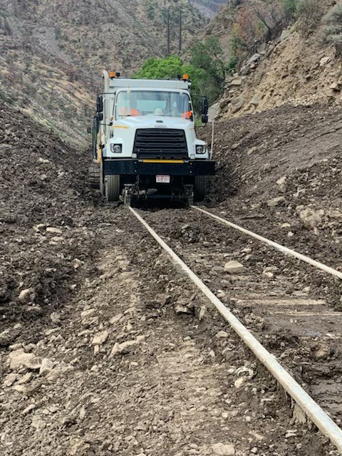 Hi-Rail truck on tracks surrounded by mudslide