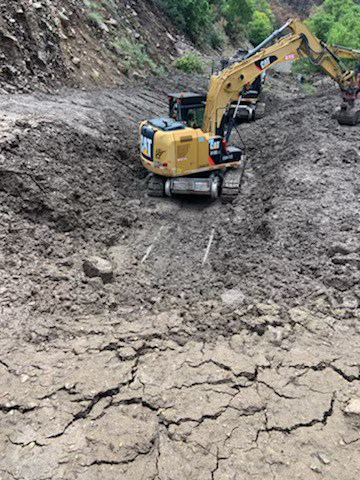 Heavy machinery working in mudslide