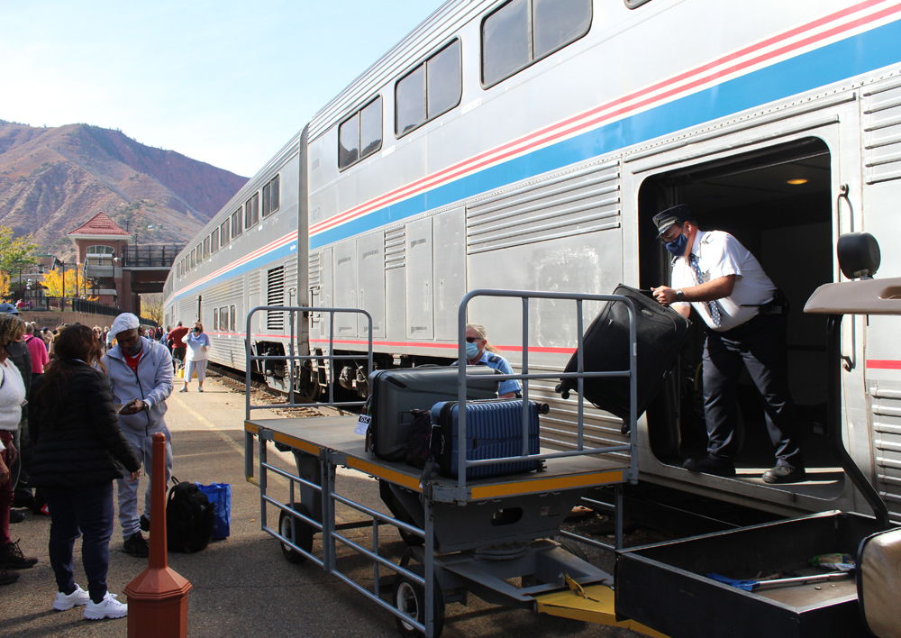 Man unloads luggage from Superliner car