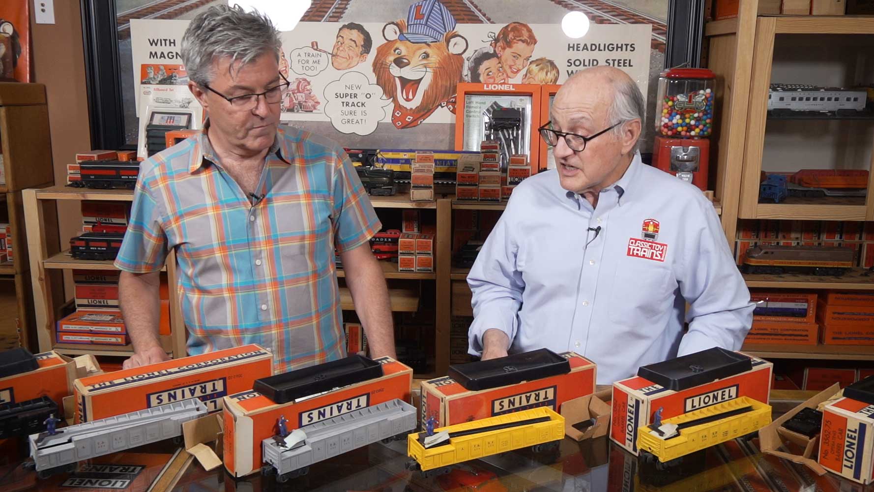 John Truckenbrod and Roger Carp display a collection of Lionel barrel cars.